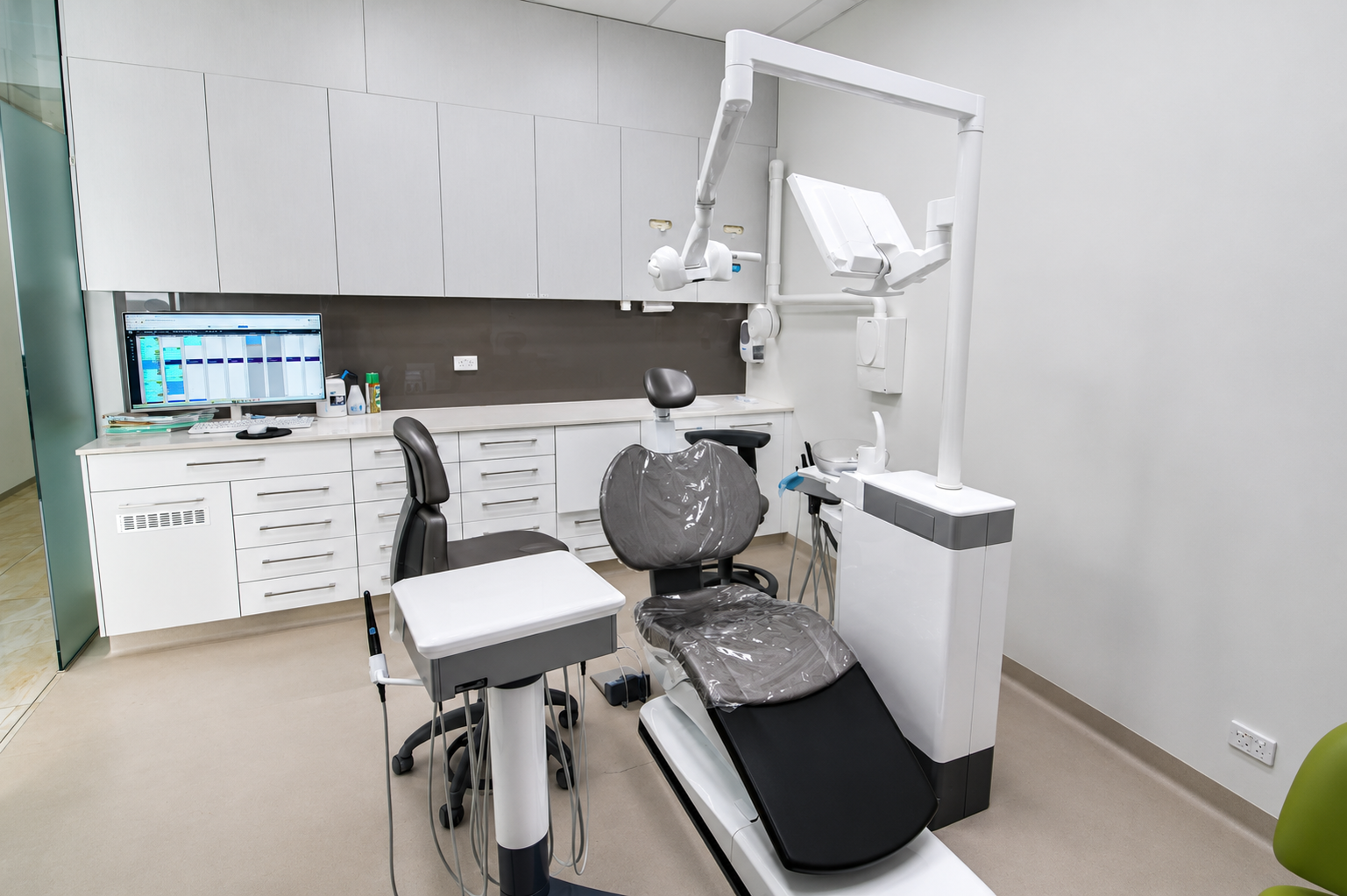 Specialist treatment room featuring operating microscope and dental chair