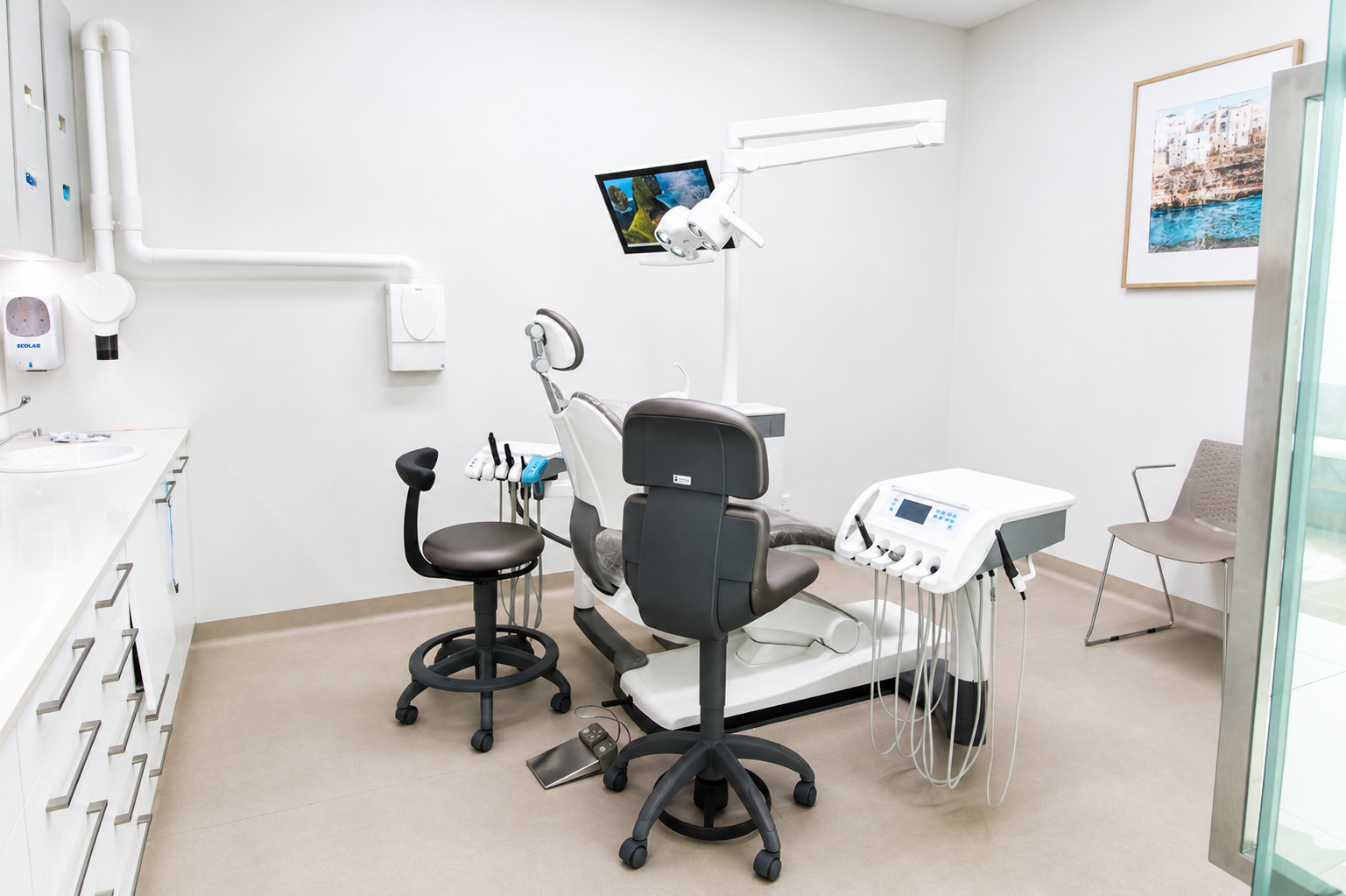 Specialist treatment room featuring operating microscope and dental chair