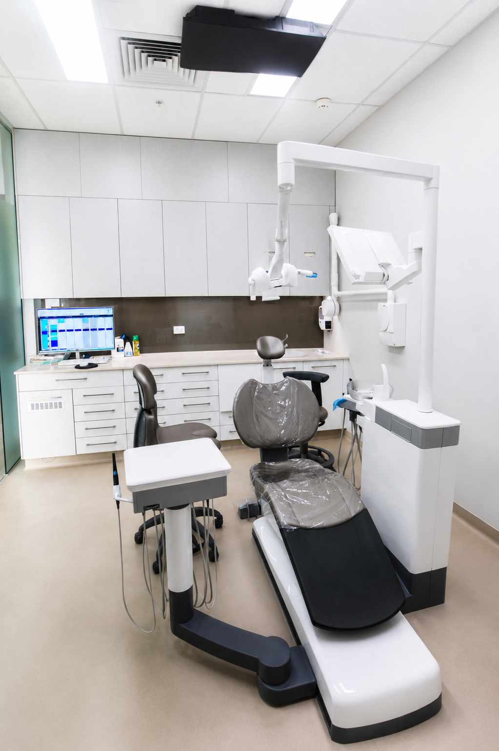 Specialist treatment room featuring operating microscope and dental chair